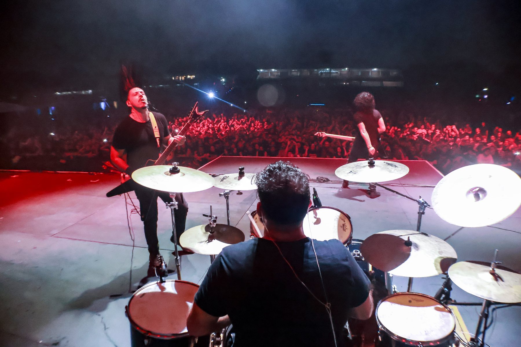 Behind the drums